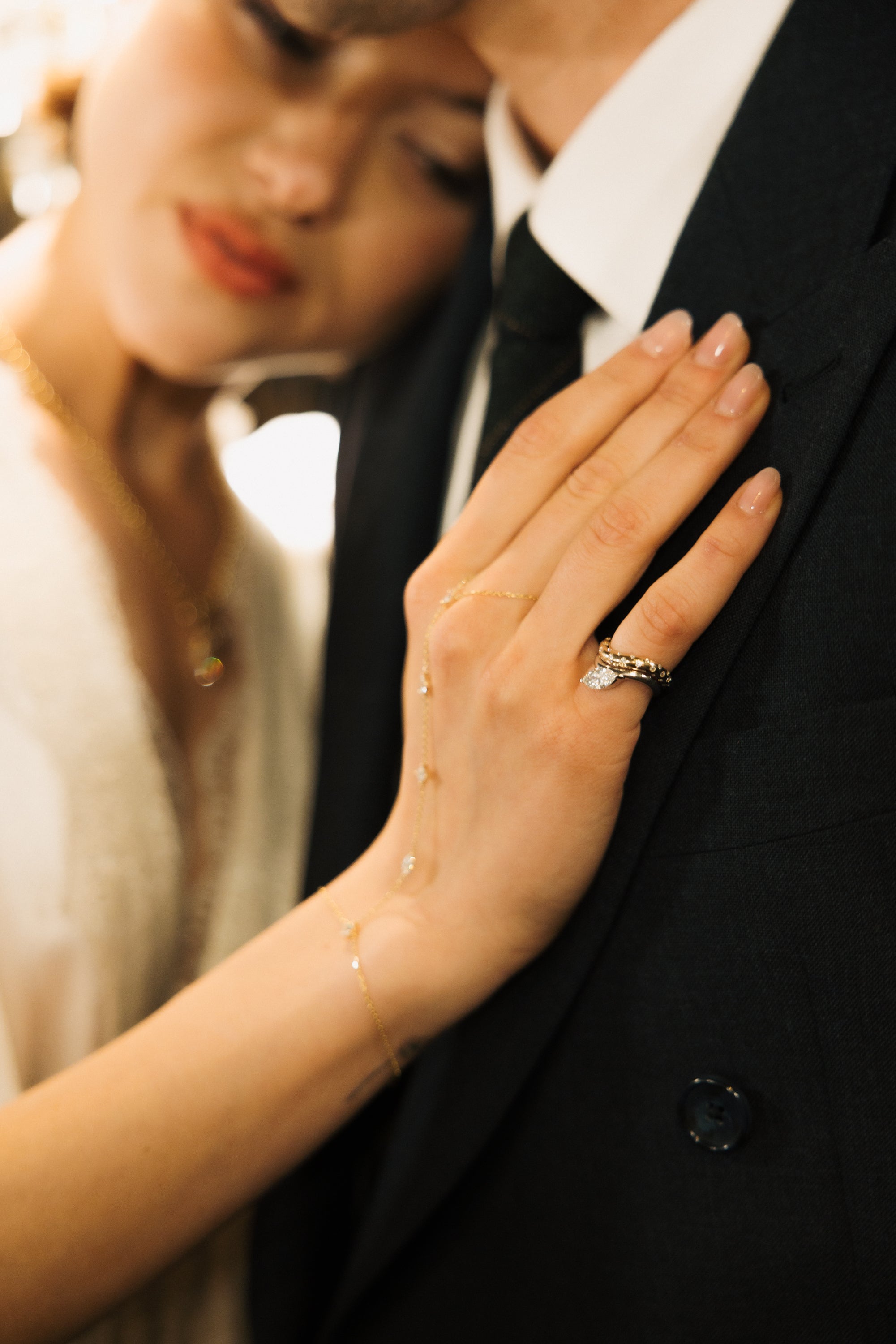 AREK Natalie Polka Dot Wave Ring worn on hand — editorial couple portrait with gold rings visible